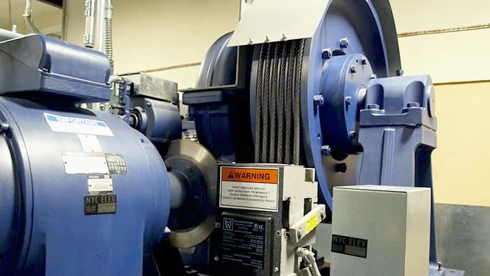 Geared Traction motor and cables inside an elevator machine room