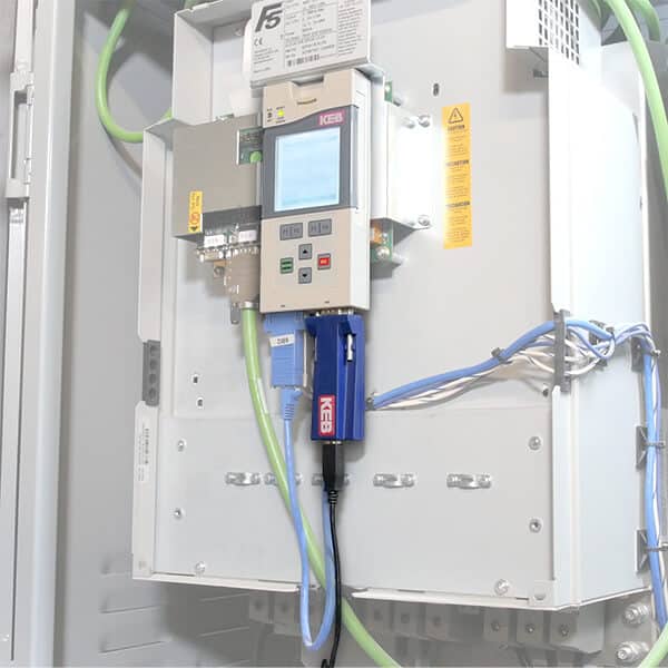 KEB Automation Blue computer adaptor connected to an F5 drive in an elevator application to begin a Parameter Scope Trace for troubleshooting